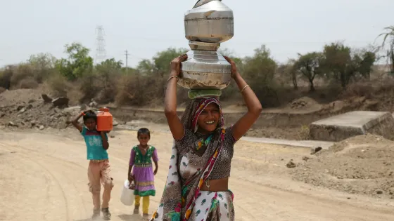 Woman and Children carrying water